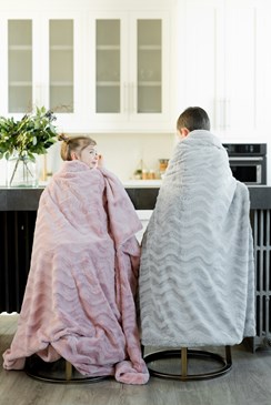 girl and boy sitting on barstools wearing blanket in Arlington Washington home kitchen